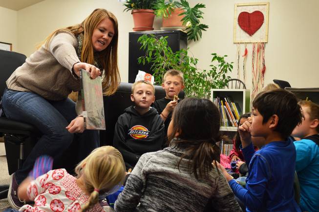 Michael-Ann Lazzarino shows children a book in the children's book nook in Virginia City in 2013. Lazzarino is the elementary programs director of Community Chest, a nonprofit group that opened the book nook last year  in its community center.  The Storey County Public Library closed in 2012.